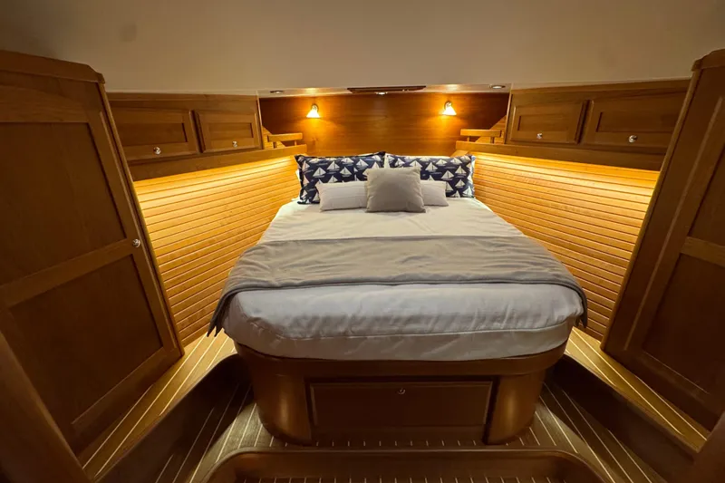 Moving On Yacht Photos Pics Luxurious cabin interior of 2022 Sabre 48 Salon Express yacht with cozy bedding.