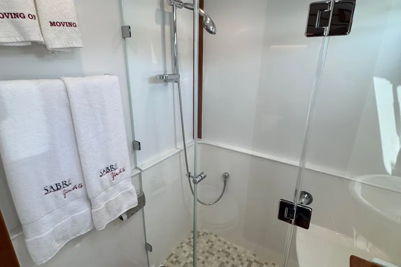 Moving On Yacht Photos Pics Modern shower in 2022 Sabre 48 Salon Express yacht with branded towels.