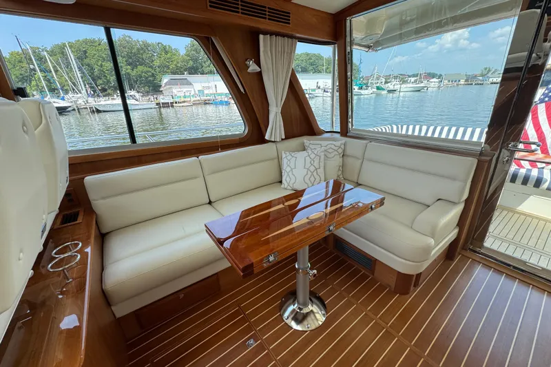 Moving On Yacht Photos Pics Luxurious interior of 2022 Sabre 48 Salon Express yacht with elegant seating and wooden table.