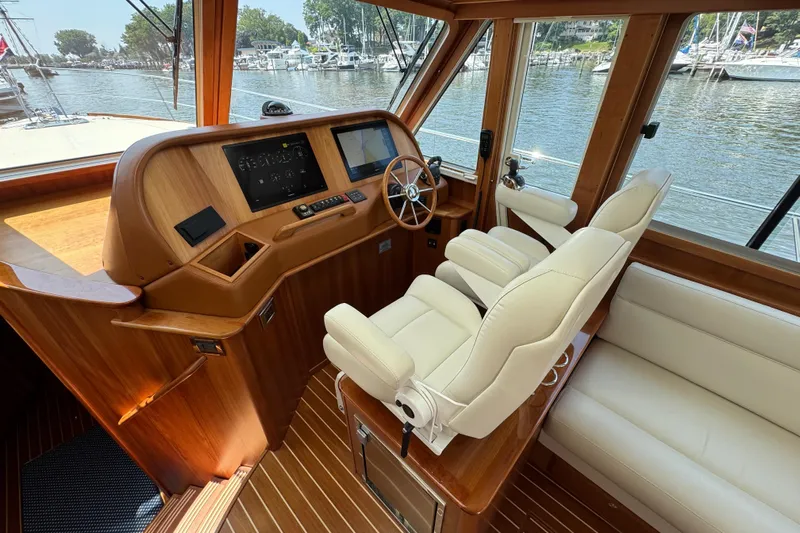 Moving On Yacht Photos Pics 2022 Sabre 48 Salon Express helm with luxurious seating and modern navigation controls.