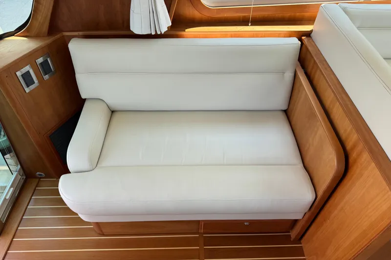 Moving On Yacht Photos Pics Luxurious white seating in 2022 Sabre 48 Salon Express yacht interior.