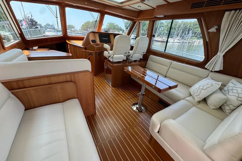 Moving On Yacht Photos Pics Luxurious interior of 2022 Sabre 48 Salon Express yacht with elegant seating and wooden finishes.