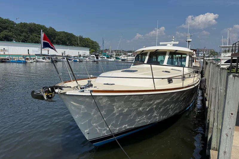 Moving On Yacht Photos Pics 2022 Sabre 48 Salon Express yacht docked at marina under clear sky.