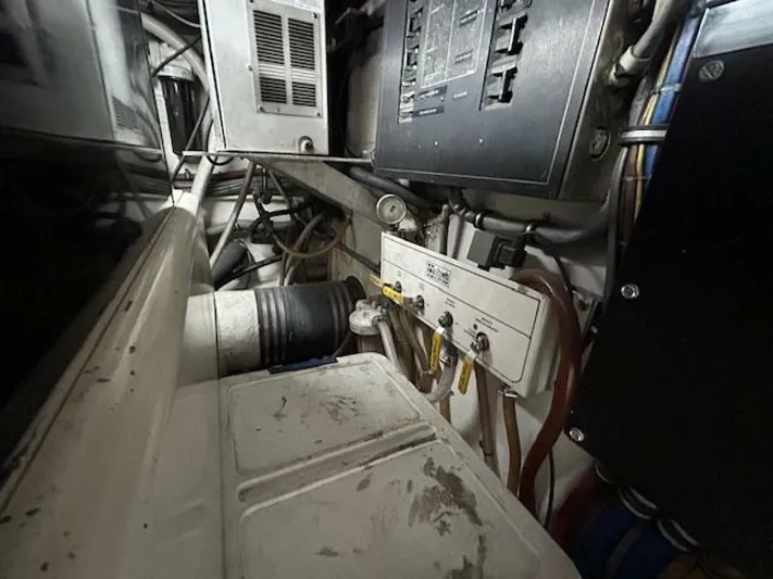 Code Vessel Yacht Photos Pics Engine room of 1989 Hatteras Convertible boat, showing electrical panels and wiring.