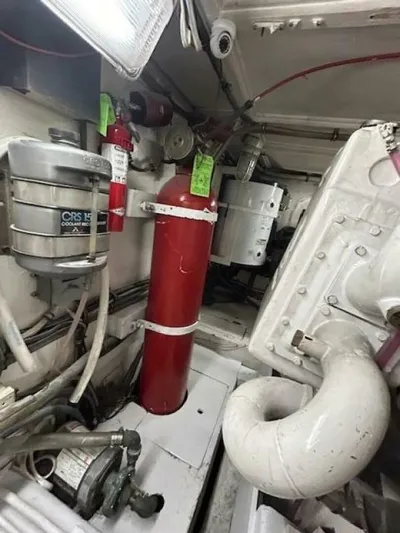 Code Vessel Yacht Photos Pics Engine room of 1989 Hatteras Convertible boat with fire extinguisher and machinery.