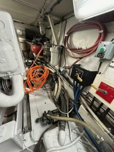 Code Vessel Yacht Photos Pics Engine room of 1989 Hatteras Convertible boat with cables and equipment.