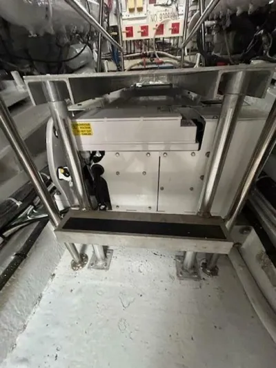 Code Vessel Yacht Photos Pics Engine room of 1989 Hatteras Convertible boat with metal framework and machinery.