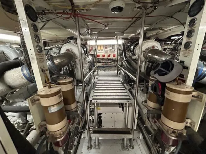 Code Vessel Yacht Photos Pics Engine room of 1989 Hatteras Convertible yacht, showcasing machinery and equipment.