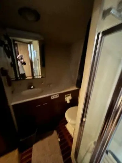 Code Vessel Yacht Photos Pics Bathroom interior of 1989 Hatteras Convertible yacht with shower and vanity.