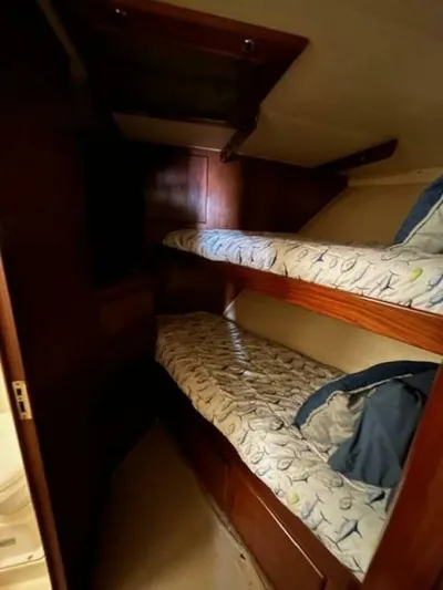 Code Vessel Yacht Photos Pics 1989 Hatteras Convertible yacht interior with wooden bunk beds.