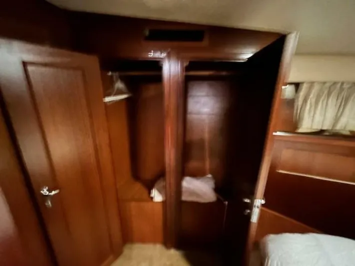 Code Vessel Yacht Photos Pics 1989 Hatteras Convertible yacht interior with wooden closets and bed.