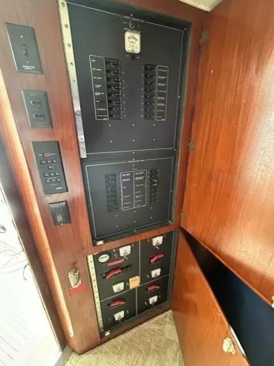 Code Vessel Yacht Photos Pics Electrical panel inside 1989 Hatteras Convertible boat, featuring circuit breakers and controls.