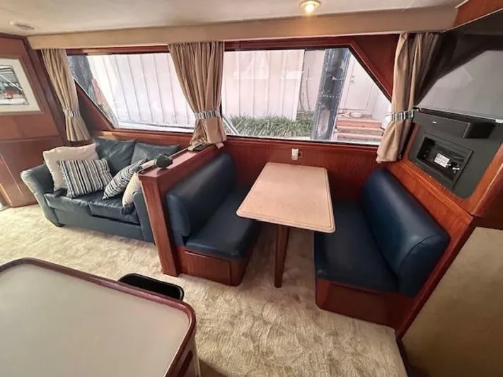 Code Vessel Yacht Photos Pics Interior of 1989 Hatteras Convertible yacht with seating and dining area.