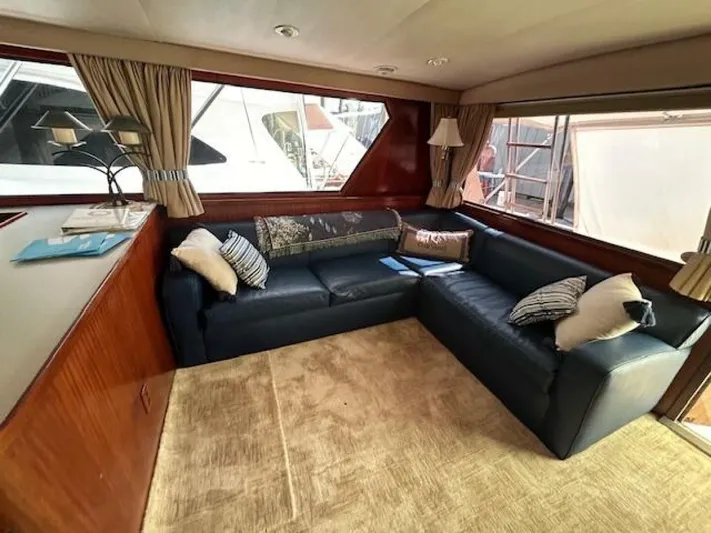 Code Vessel Yacht Photos Pics Luxurious 1989 Hatteras Convertible yacht interior with cozy seating and elegant decor.