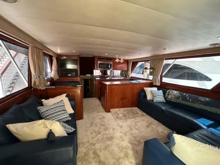 Code Vessel Yacht Photos Pics Luxurious 1989 Hatteras Convertible yacht interior with plush seating and modern kitchen.