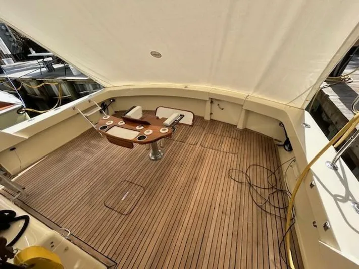 Code Vessel Yacht Photos Pics 1989 Hatteras Convertible yacht deck with wooden flooring and fishing chair.