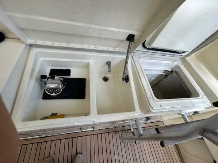 Code Vessel Yacht Photos Pics 1989 Hatteras Convertible boat sink and storage compartments on deck.