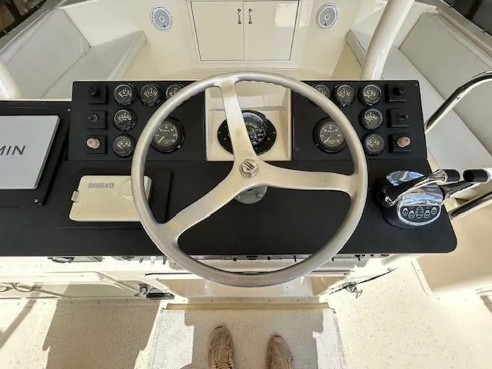 Code Vessel Yacht Photos Pics 1989 Hatteras Convertible boat helm with steering wheel and control panel.