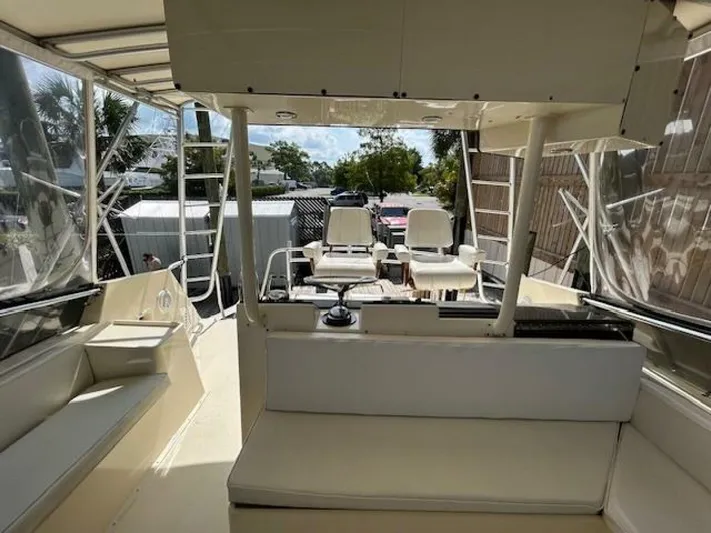 Code Vessel Yacht Photos Pics 1989 Hatteras Convertible boat interior with seating and helm station.