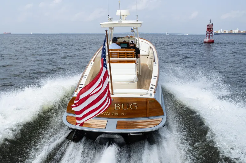Sea Bug Yacht Photos Pics 2017 Hinckley Talaria 29C cruising with American flag on open water.
