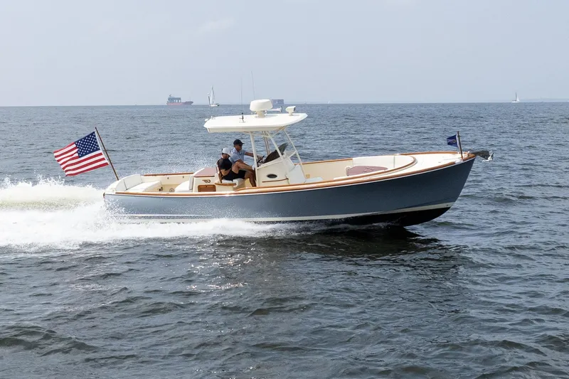 Sea Bug Yacht Photos Pics 2017 Hinckley Talaria 29C cruising on open water with American flag.