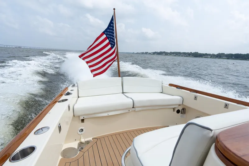 Sea Bug Yacht Photos Pics 2017 Hinckley Talaria 29C cruising with American flag, featuring elegant deck and seating.