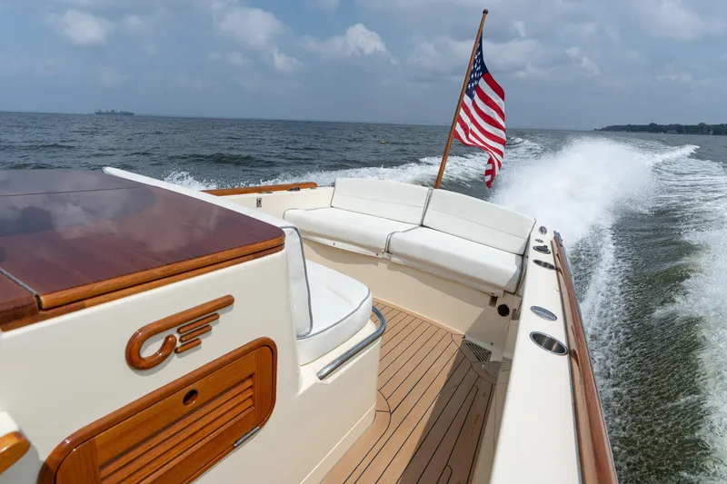 Sea Bug Yacht Photos Pics 2017 Hinckley Talaria 29C cruising on open water with American flag waving.