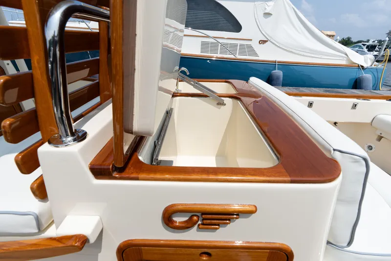 Sea Bug Yacht Photos Pics 2017 Hinckley Talaria 29C boat interior with elegant wood finish and storage compartment.