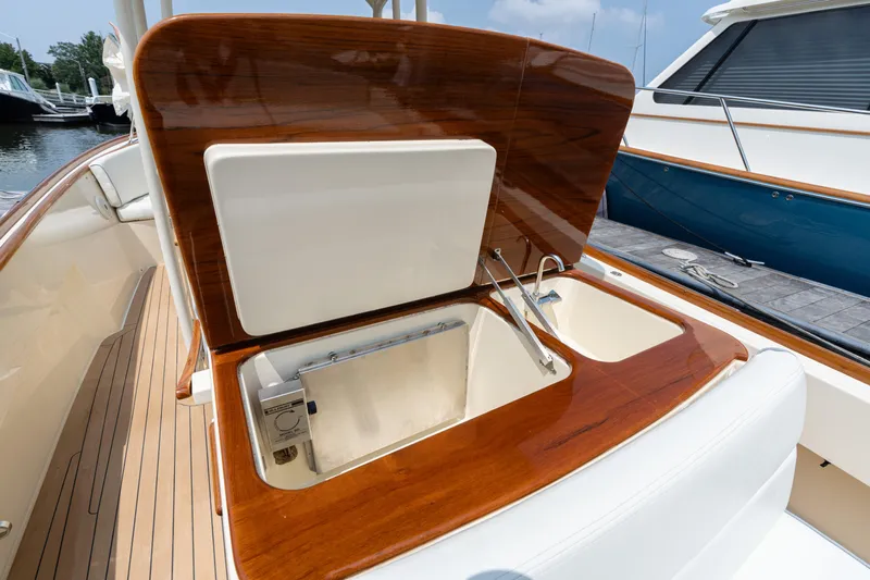 Sea Bug Yacht Photos Pics 2017 Hinckley Talaria 29C boat interior with open storage compartment and wooden finish.
