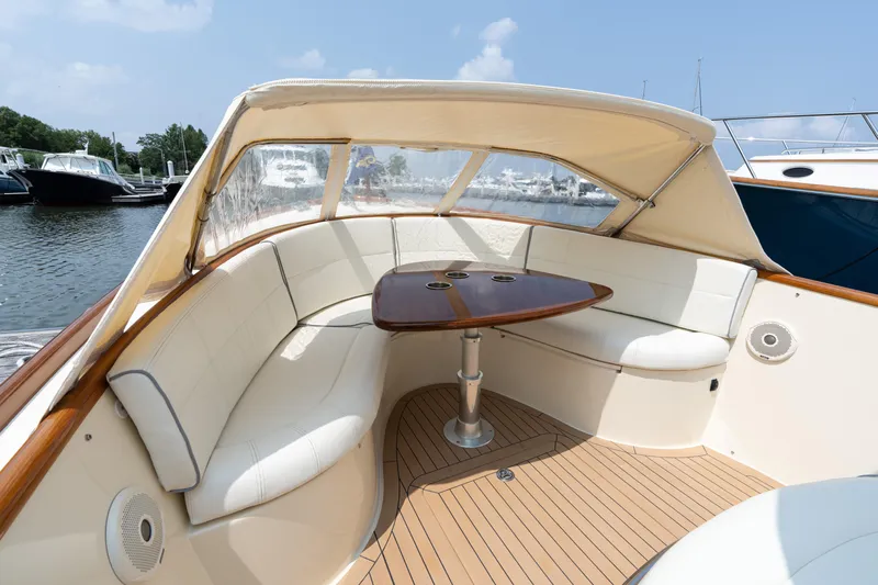 Sea Bug Yacht Photos Pics 2017 Hinckley Talaria 29C boat interior with cushioned seating and wooden table.
