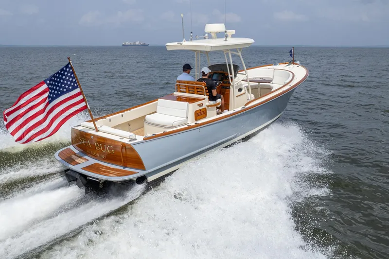 Sea Bug Yacht Photos Pics 2017 Hinckley Talaria 29C boat cruising with American flag on open water.