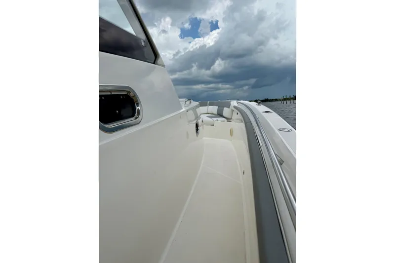 Seakeeper Yacht Photos Pics 2020 Pursuit S 408 Sport boat on water under cloudy sky.