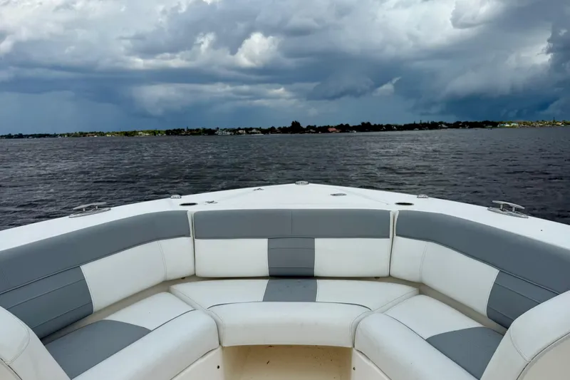 Seakeeper Yacht Photos Pics Bow seating on 2020 Pursuit S 408 Sport boat with stormy sky over water.