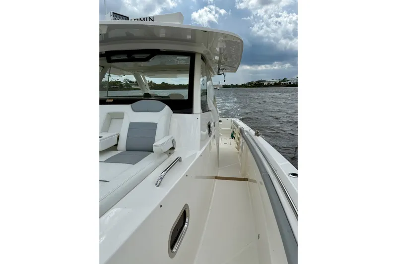 Seakeeper Yacht Photos Pics 2020 Pursuit S 408 Sport boat on water, showcasing sleek design and spacious deck.