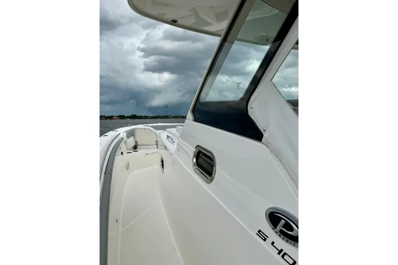 Seakeeper Yacht Photos Pics 2020 Pursuit S 408 Sport boat on water under cloudy sky.