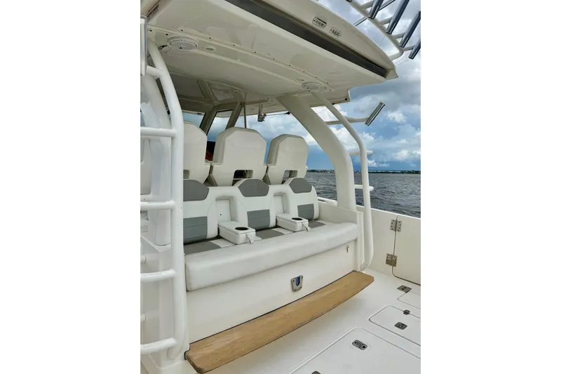 Seakeeper Yacht Photos Pics 2020 Pursuit S 408 Sport boat interior with cushioned seating and ocean view.