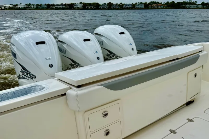 Seakeeper Yacht Photos Pics 2020 Pursuit S 408 Sport boat with triple Yamaha outboard engines on water.