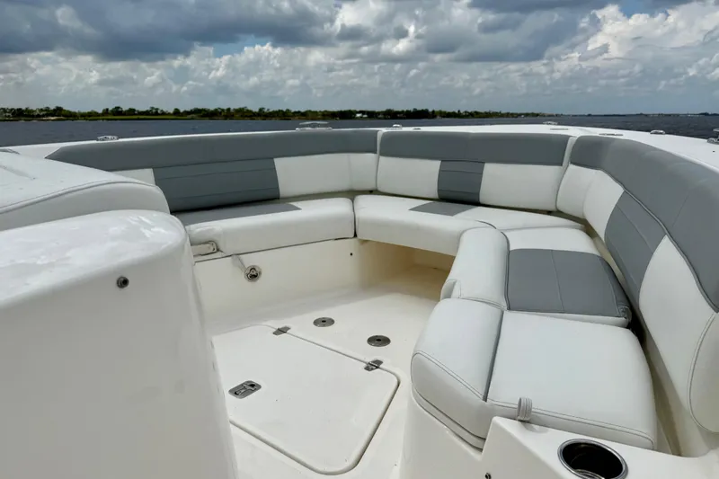 Seakeeper Yacht Photos Pics 2020 Pursuit S 408 Sport boat with spacious seating under cloudy skies.