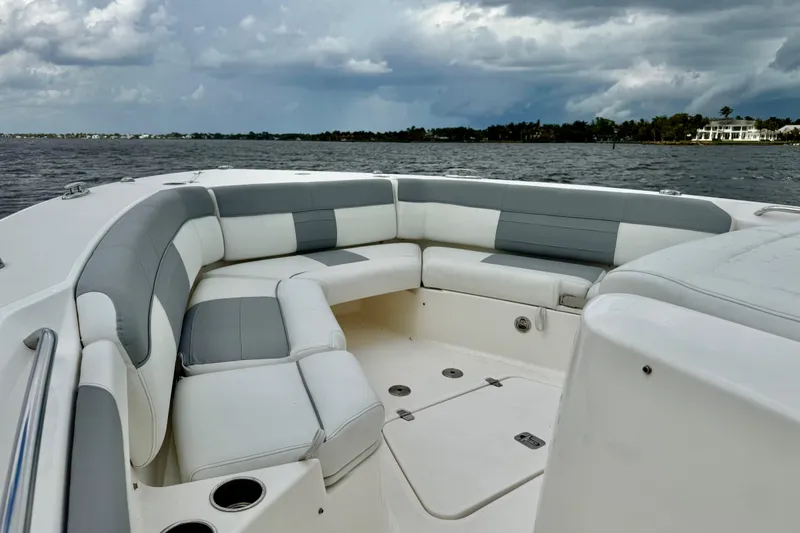 Seakeeper Yacht Photos Pics 2020 Pursuit S 408 Sport boat interior with cushioned seating on open water.
