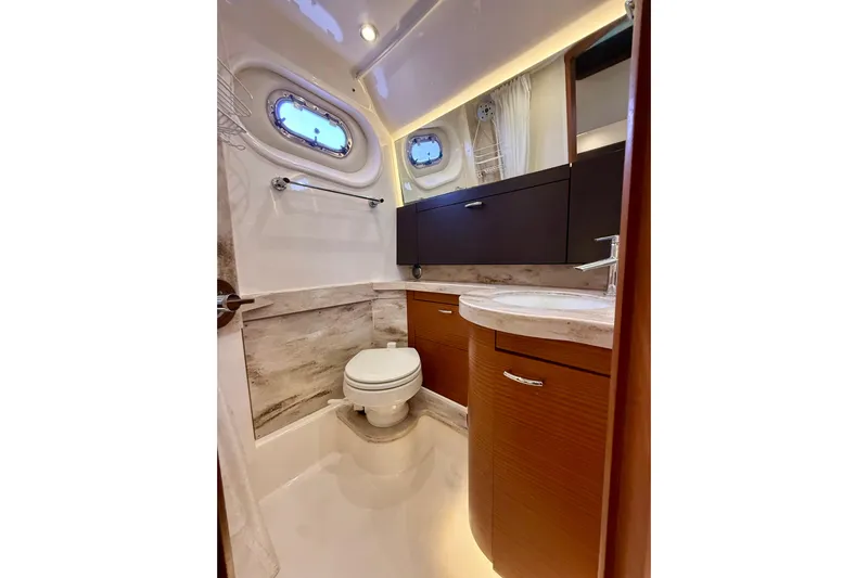 Seakeeper Yacht Photos Pics Luxurious bathroom in 2020 Pursuit S 408 Sport boat with modern fixtures and wood cabinetry.