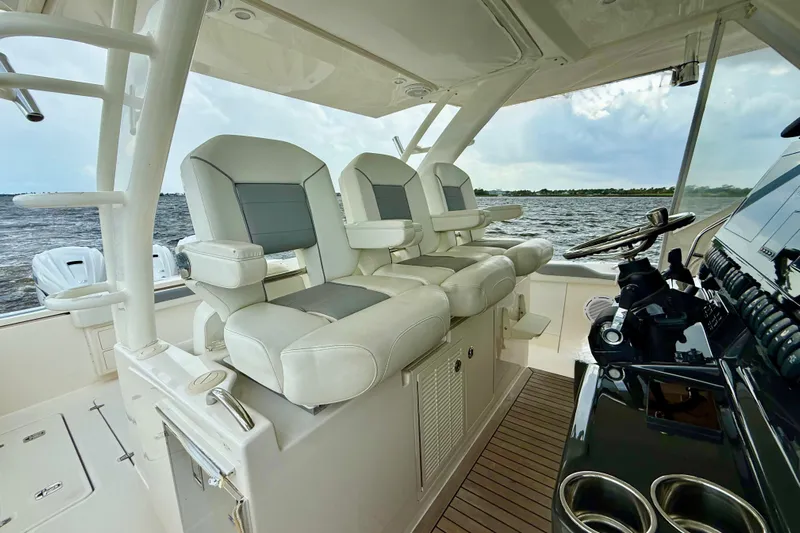 Seakeeper Yacht Photos Pics 2020 Pursuit S 408 Sport boat interior with luxurious seating and helm controls.