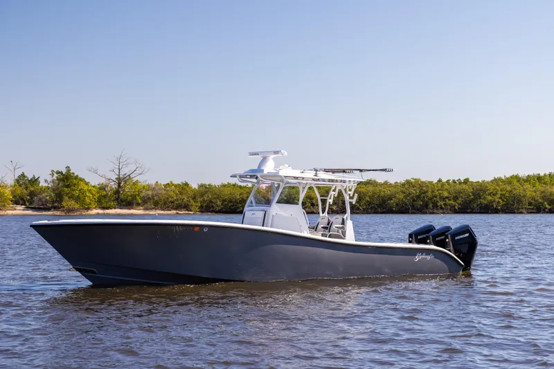 Bid Time 2 Yacht Photos Pics 2023 Yellowfin 36 Offshore boat on calm water with clear sky background.