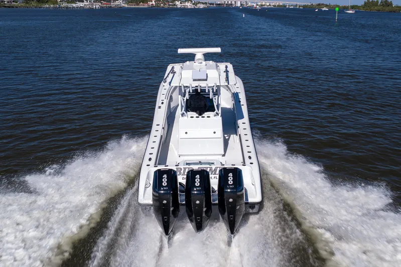 Bid Time 2 Yacht Photos Pics 2023 Yellowfin 36 Offshore boat cruising on a calm river with triple outboard engines.