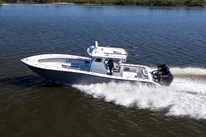 Bid Time 2 Yacht Photos Pics 2023 Yellowfin 36 Offshore boat cruising on a calm lake.