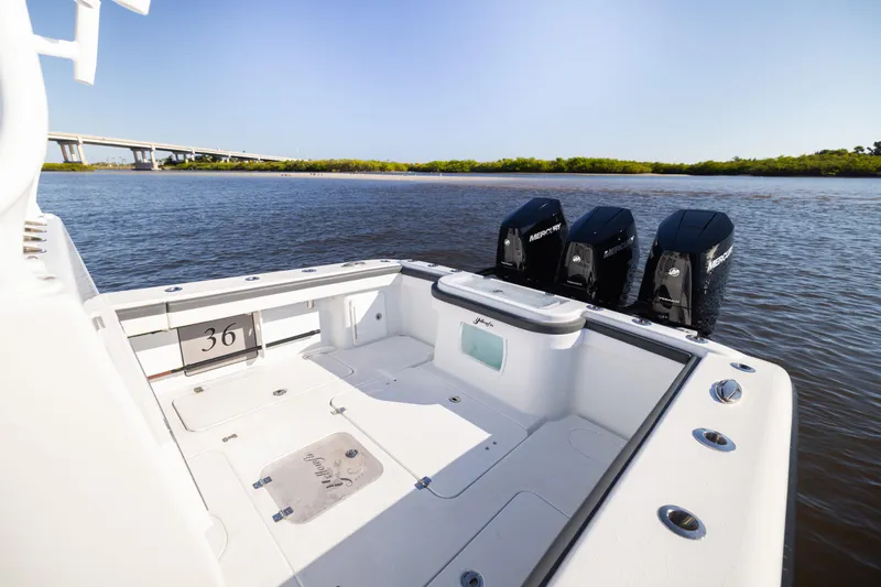 Bid Time 2 Yacht Photos Pics 2023 Yellowfin 36 Offshore boat with triple Mercury engines on calm water.