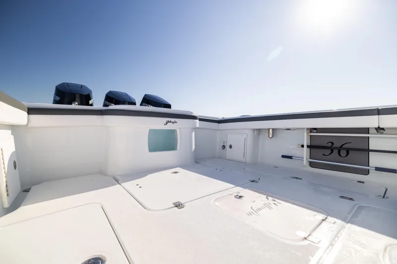 Bid Time 2 Yacht Photos Pics 2023 Yellowfin 36 Offshore boat deck with triple Mercury engines under clear sky.
