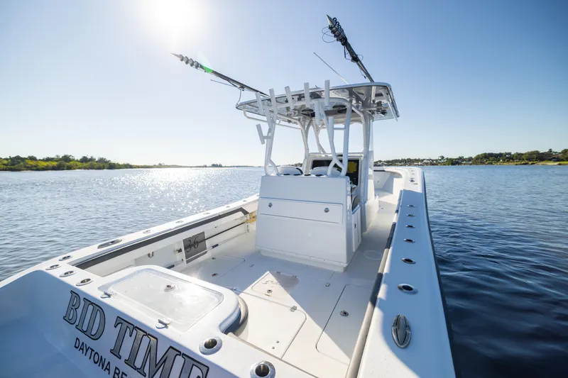 Bid Time 2 Yacht Photos Pics 2023 Yellowfin 36 Offshore boat on calm water under clear blue sky.