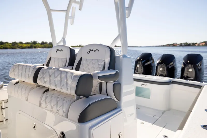 Bid Time 2 Yacht Photos Pics 2023 Yellowfin 36 Offshore boat with luxurious seating and powerful engines on a sunny day.