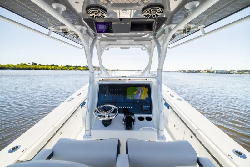 Bid Time 2 Yacht Photos Pics 2023 Yellowfin 36 Offshore boat interior with advanced navigation system on calm water.