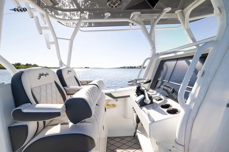 Bid Time 2 Yacht Photos Pics 2023 Yellowfin 36 Offshore boat interior with luxury seating and modern controls.